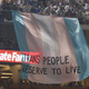 Illustration for article titled Activists Display Huge Trans People Deserve To Live Banner During World Series
